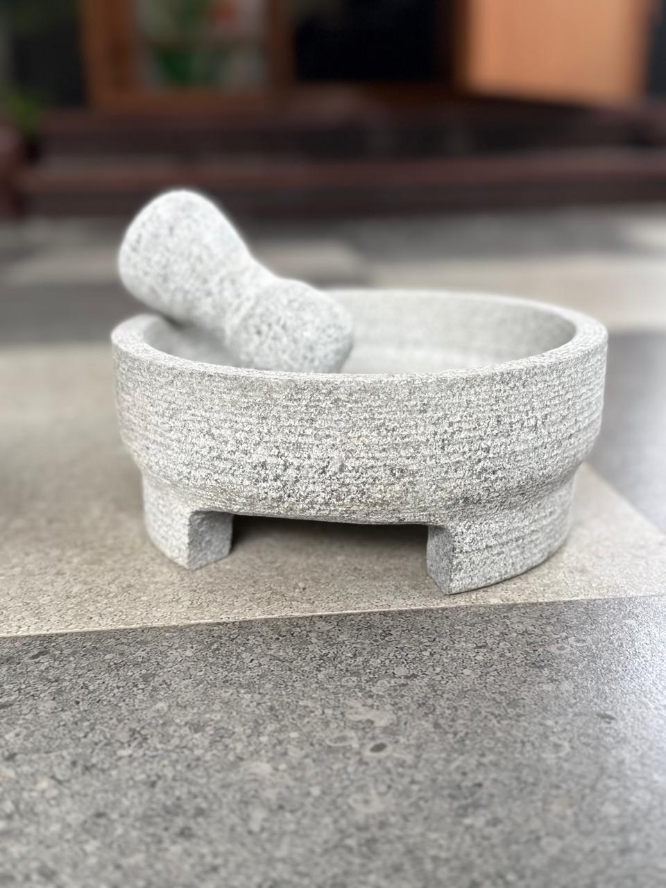 Stone mortar and pestle with tripod legs